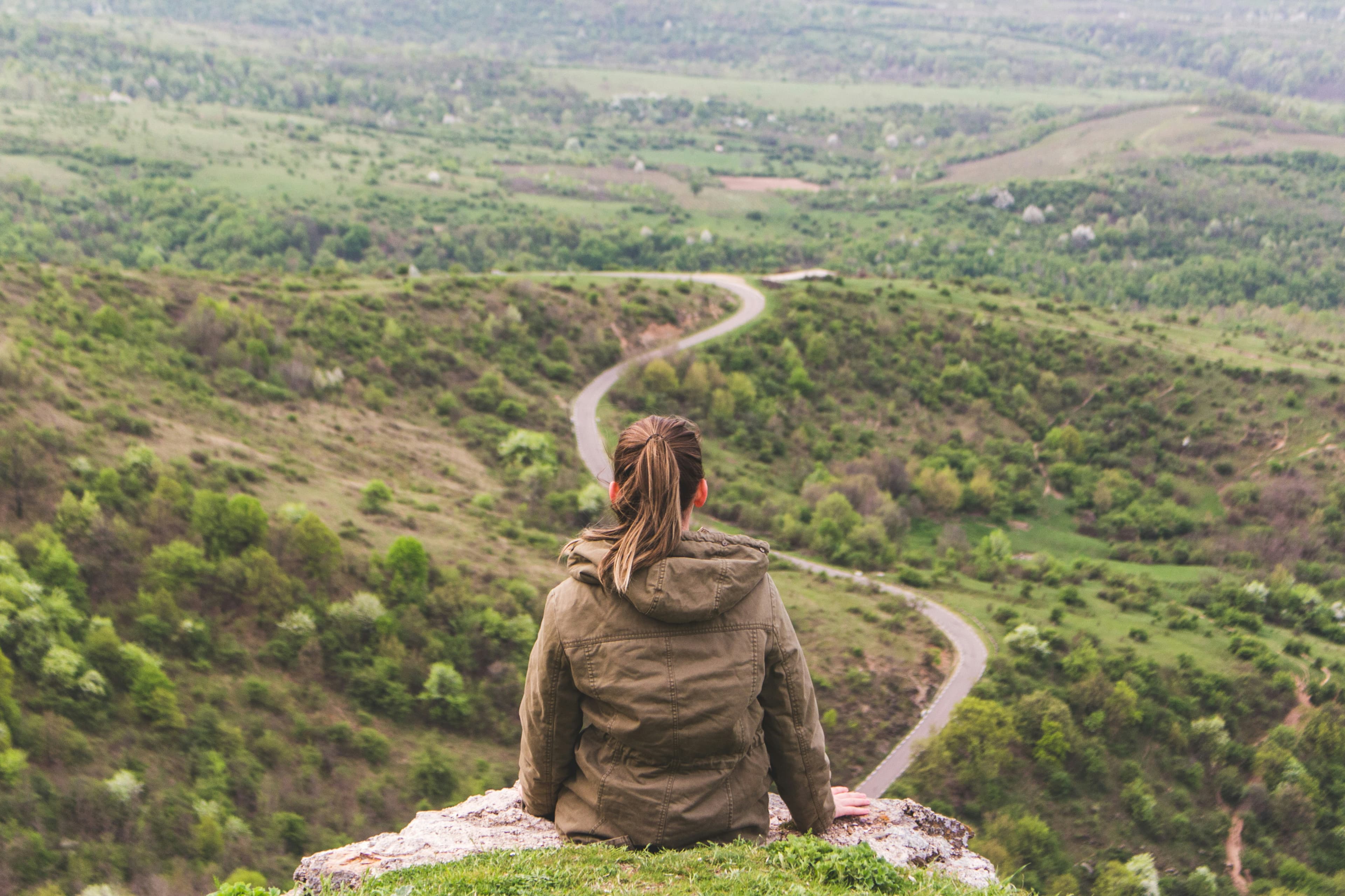 Woman at the top of a mountain looking out at the view